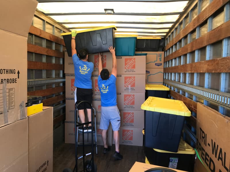 Professional office movers loading a truck