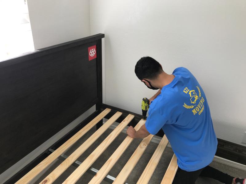 KZ2 professional mover assembling a bed frame