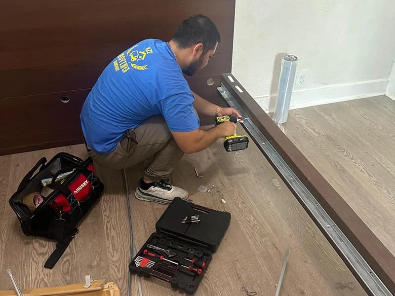 KZ2 professional mover assembling a bed frame