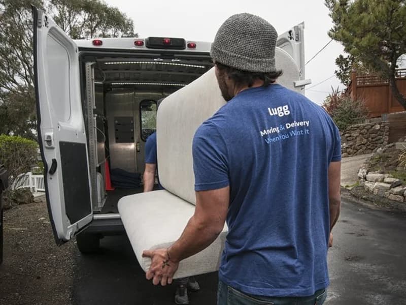 Luggers loading unprotected couch on a van